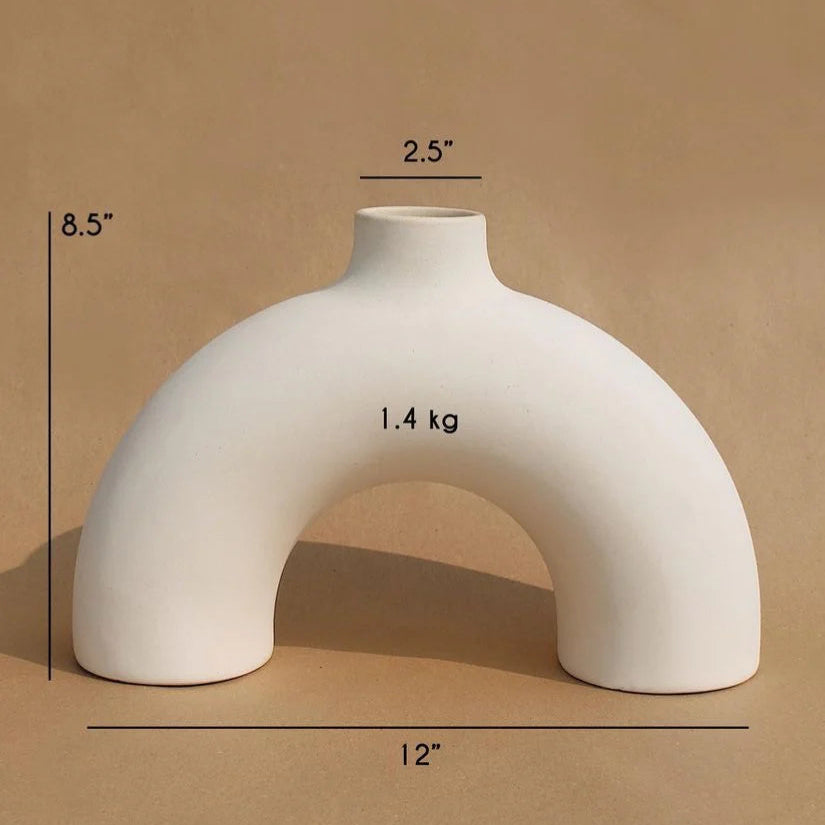 White ceramic vase with measurements on a brown background