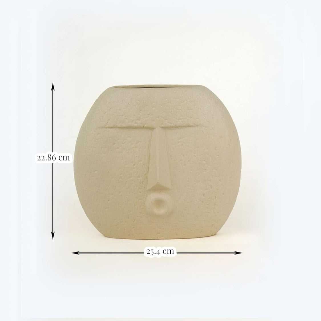 Ceramic vase with face design and measurements on a white background