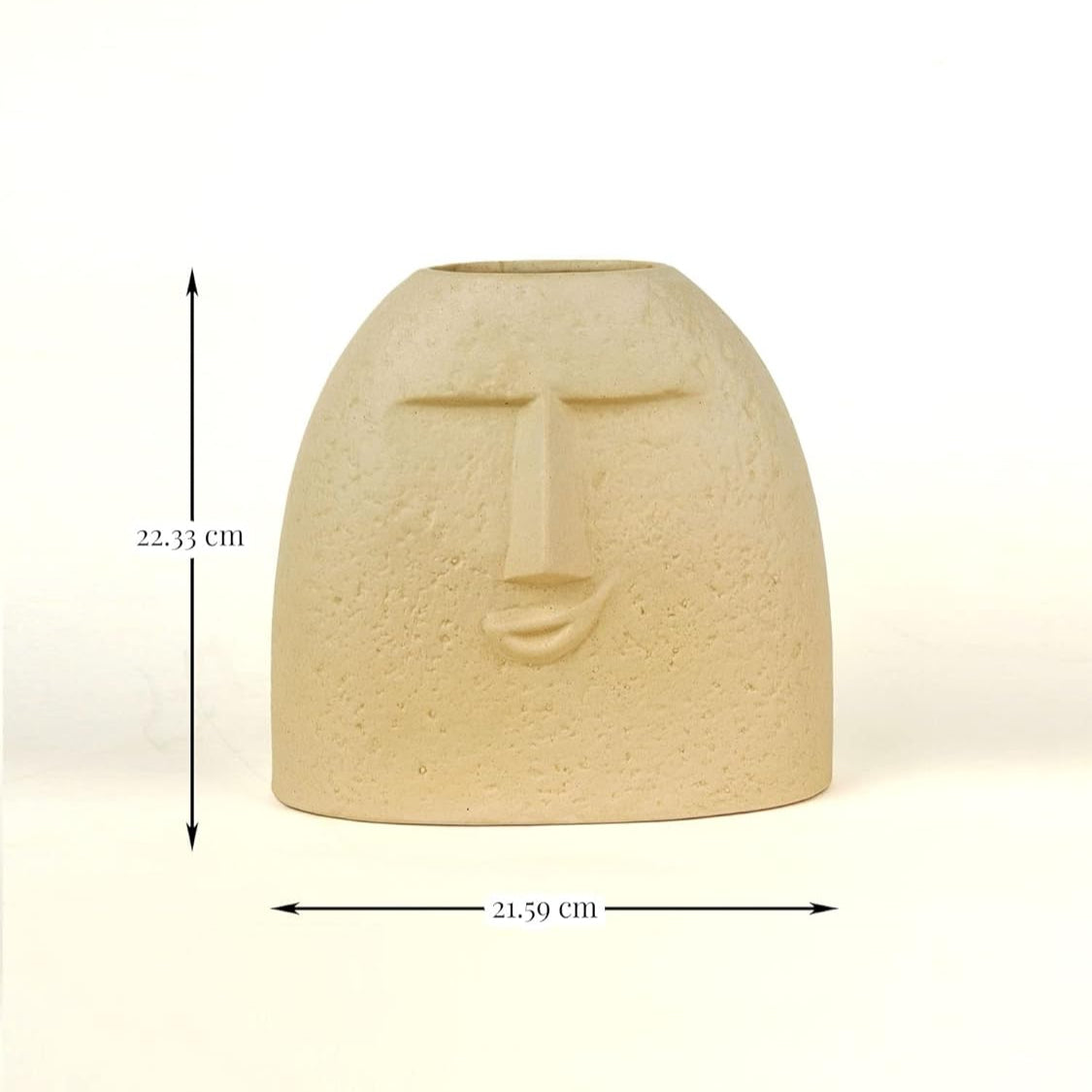 Ceramic face-shaped vase with measurements on a white background
