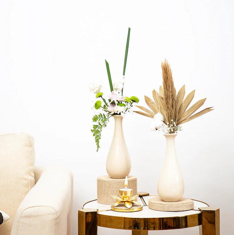 Decorative table with vases and a candle in a living room setting