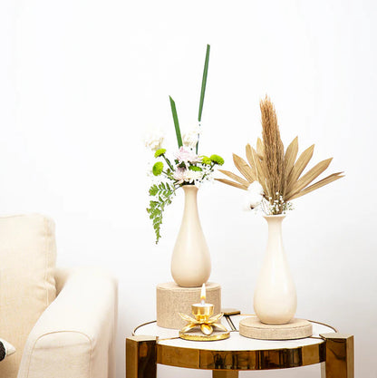 Decorative table with vases and a candle in a living room setting