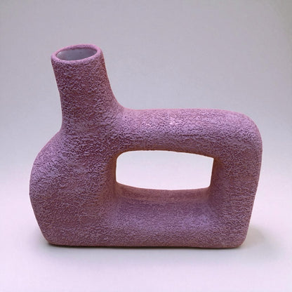 Textured purple vase on a light gray background