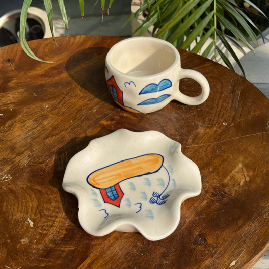 Two ceramic items with artistic designs on a wooden surface.