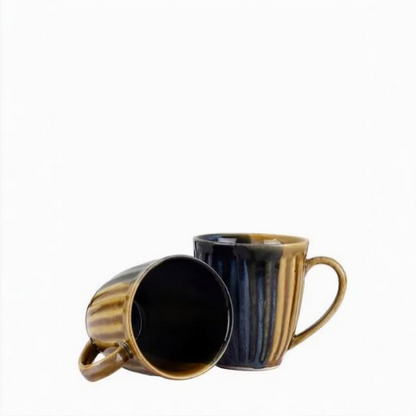 Two ceramic mugs with striped design on a white background